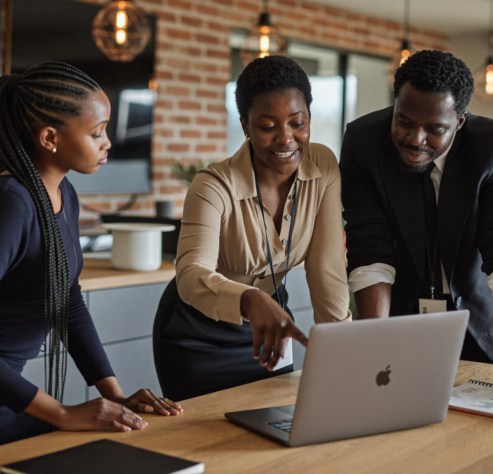 Kenyan business colleagues reviewing sales information together on a laptop